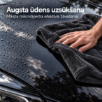 Hand using a dark grey NANO GO microfiber towel to dry water droplets from a black car bonnet